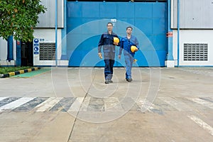 Two workers walking out from factory after work