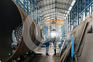 Two workers wearing yellow hard hat and blue uniform