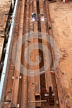 Two workers welding steel