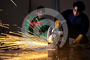 Two workers are welding steel in industrial plants