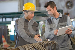 Two workers working in factory