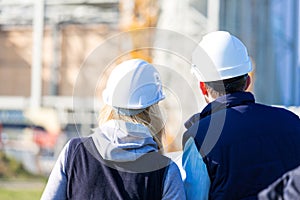 Two workers working outside on a construction site