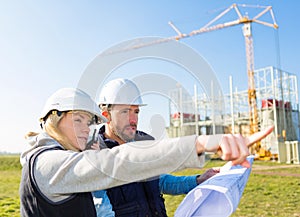 Two workers working outside on a construction site