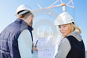 Two workers working outside on a construction site