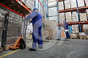 Two workers working in storehouse