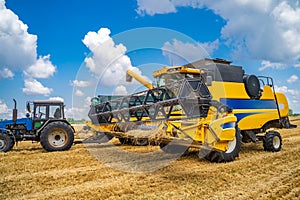 Two working gathering harvest machines. Harvest gathering in gold field. Dry wheat.