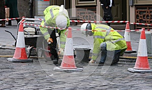Two workman repairing pavement photo
