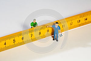 Two Workmen Figurines With A Ruler
