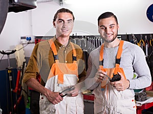 Two workmen toiling in workshop