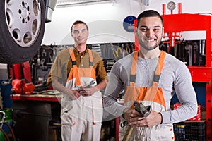 Two workmen toiling in workshop