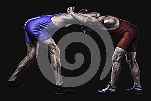 Two wrestlers holding each other in stand