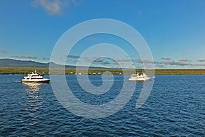 Two yachts cruising in the ocean near Galapagos islands