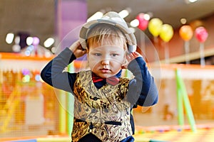 Two-year kid in a hat and tie a butterfly, baby`s birthday