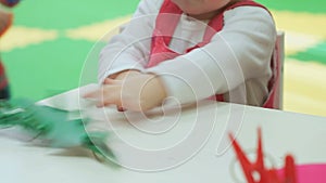 Two-year old baby girl plays with toys