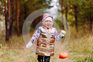 Two-year-old girl and orange pumpkin photo