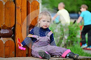 Two year old girl on park bench