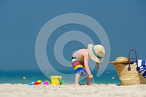 Two year old toddler playing on beach