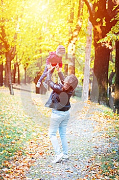 Two years old toddler have fun outdoor in autumn park