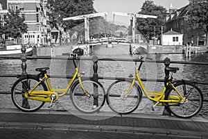 Two yellow bikes on the streets of Amsterdam