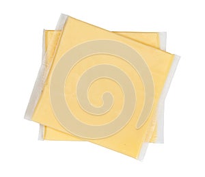 Two yellow cheese slices packaged on white background. Close-up, top view