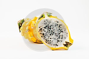 Two yellow dragon fruits on a white background. One of the frui