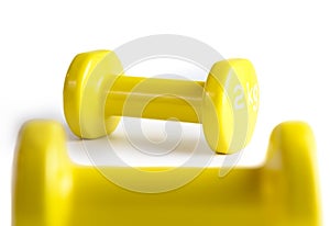 Two yellow  dumbbells isolated on white background with clipping path