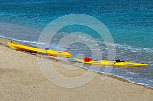 two yellow kayaks on the Mediterranean coast