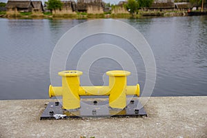 Two yellow mooring post at the harbor or marina port