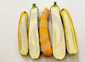 Two yellow and one green courgettes, pumpkin