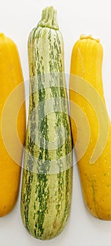 Two yellow and one green courgettes, pumpkin