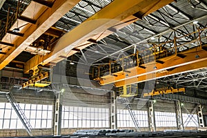 Two yellow overhead cranes in engineering plant shop photo