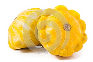 Two yellow pattypan squash isolated on white background