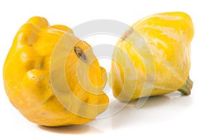 Two yellow pattypan squash isolated on white background