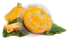 Two yellow pattypan squash with leaf and flower isolated on white background