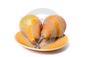 Two pears on a plate. Pears isolated on a white