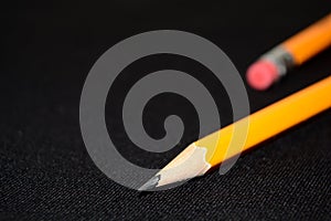 Two yellow Pencils on dark black blurred background. stationery. Office tool. Business concept.