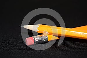 Two yellow Pencils on dark black blurred background. stationery. Office tool. Business concept.