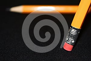 Two yellow Pencils on dark black blurred background. stationery. Office tool. Business concept.