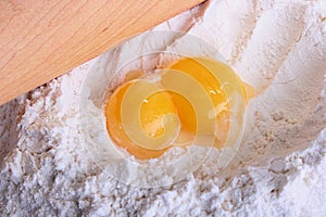 Two yolks lie on a flour