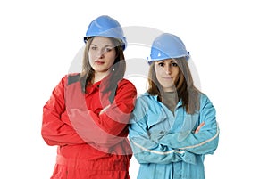 Two young apprentices with helmets and coveralls