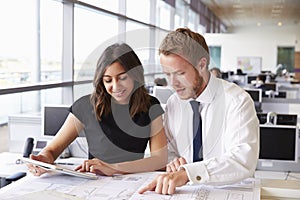 Two young architects working together in an office