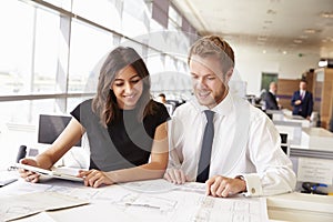 Two young architects working together in an office