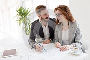 Two young architects working together in office