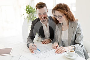 Two young architects working together in office