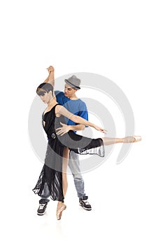 Two young artists couple dancing in studio, on pointe, whit