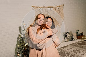 Two young asian women smiling with happiness in Christmas party, lgbt couple, friends celebration