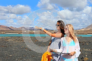 Two young attractive women with land map