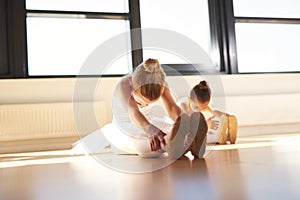 Two Young Ballerinas Exercising Inside the Studio