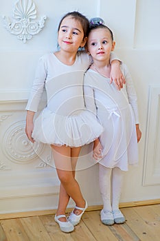 Two young ballet dancers hug