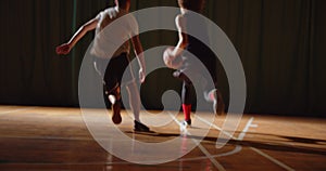 Two young basketball players play basket ball competition amateurs hall sports parquet dribbling